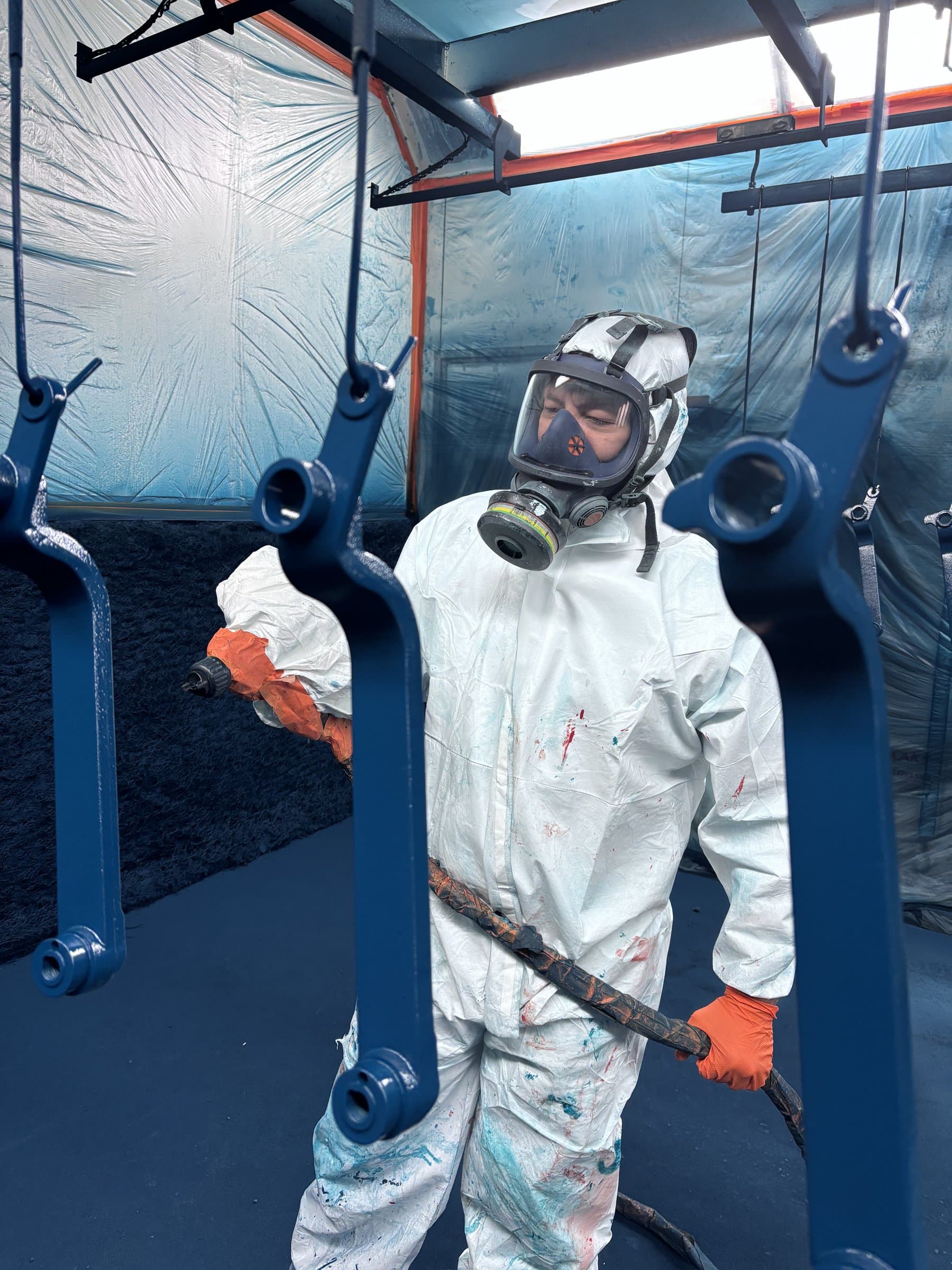 Painter inspecting finished components